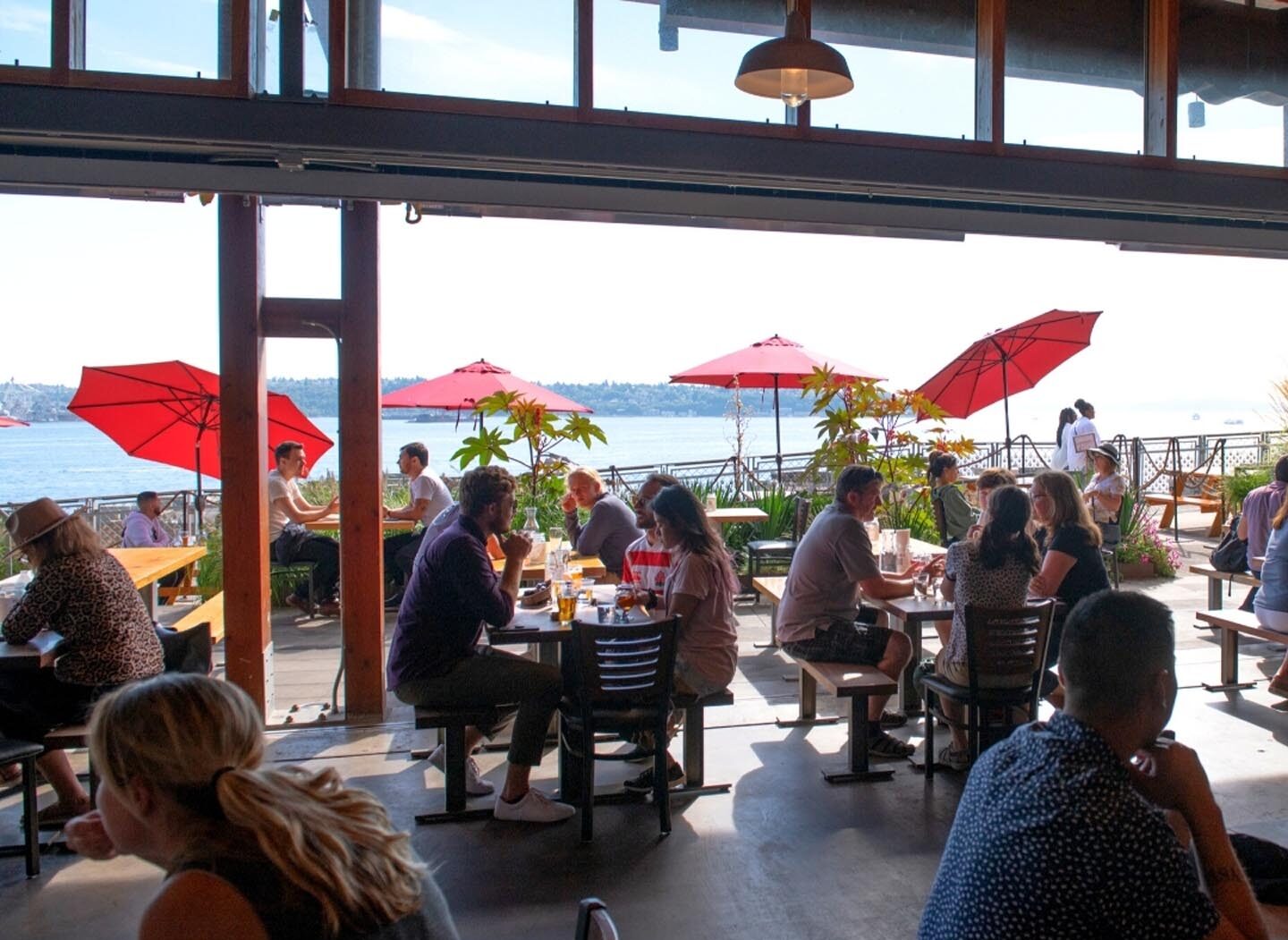 patrons enjoying a sunny summer day at old stove brewery at pike place market 
