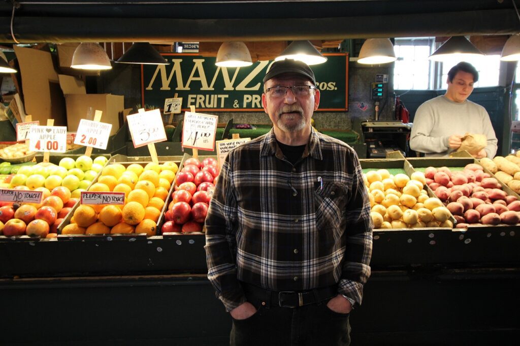 Mario "Mark" Manzo in front of his produce stand on March 29, 2022.