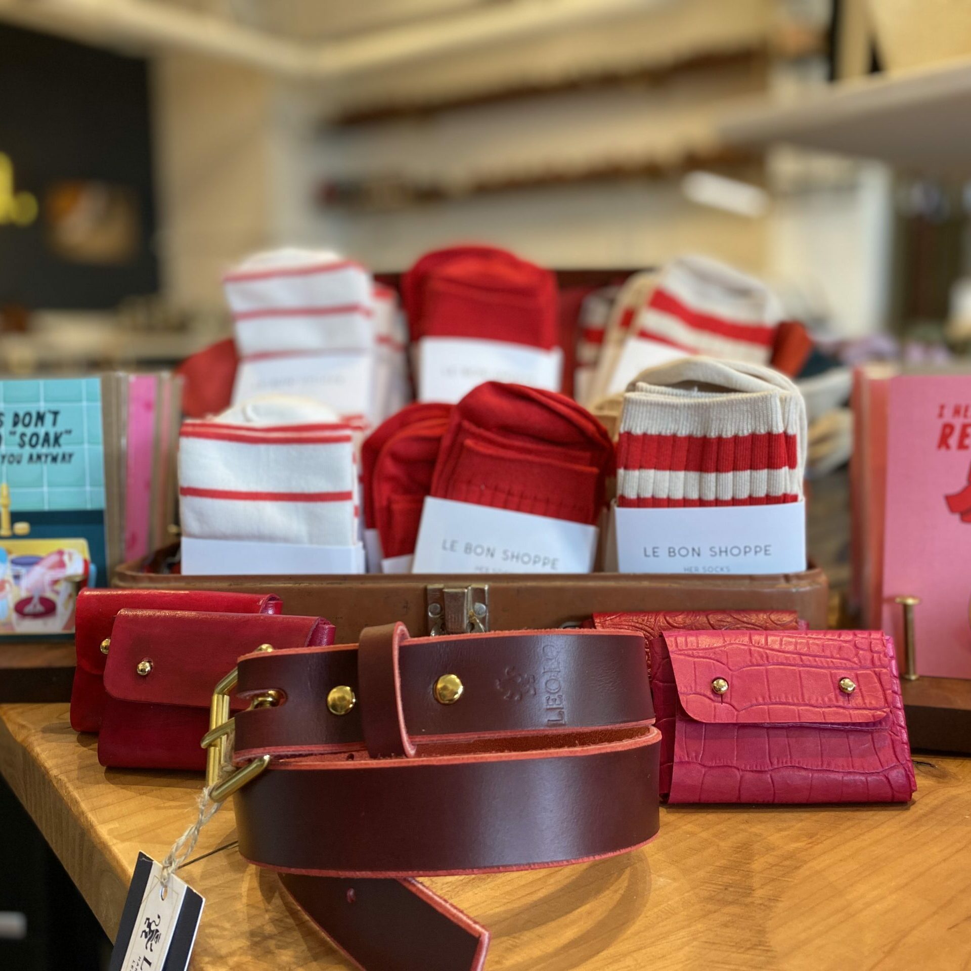 Valentine's Day themed socks, red and pink leather belts and wallets at LEOLO Handmade shoes and leather goods in Pike Place Market