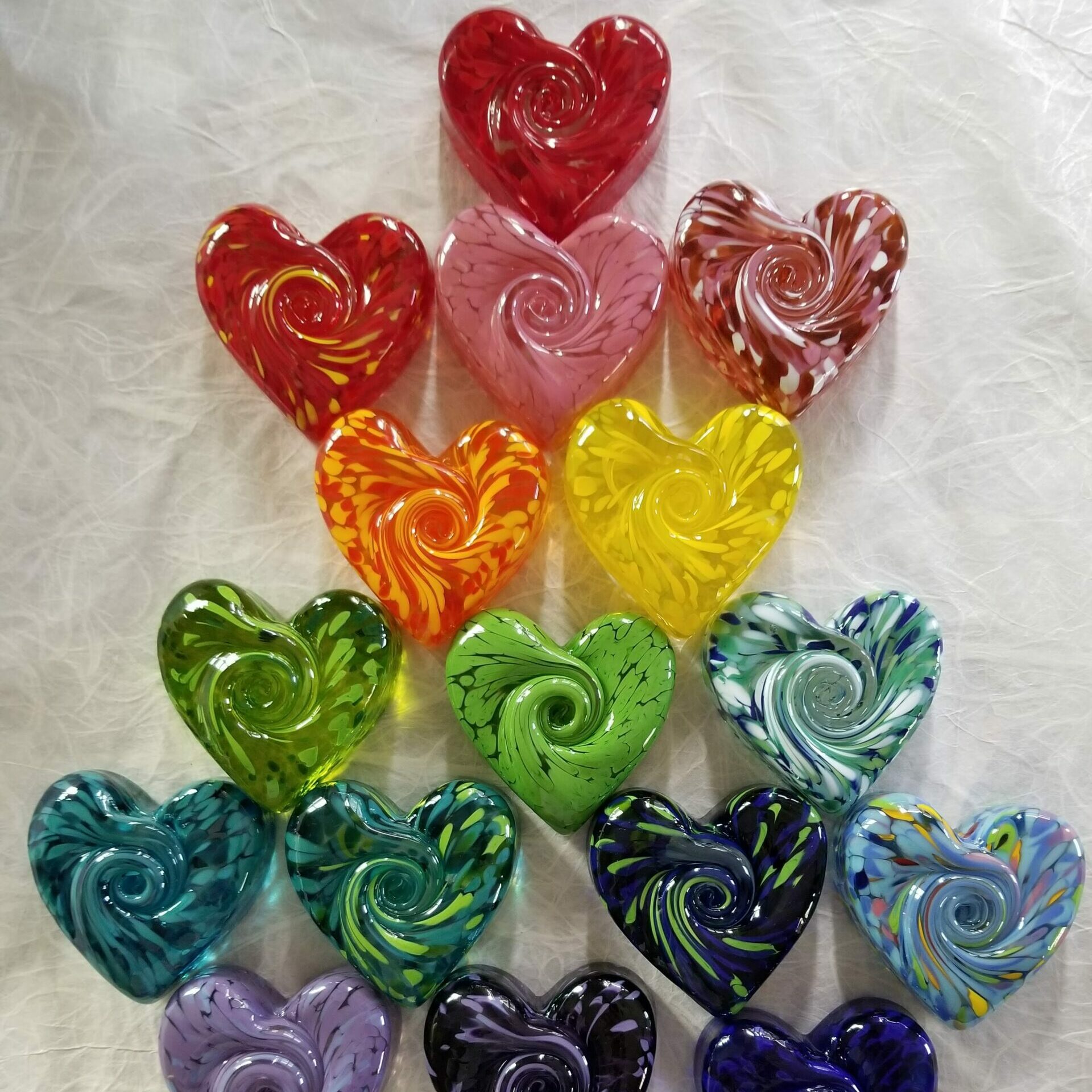 photo of handmade glass heart paperweights in every color of the rainbow by kobo art garden in pike place market
