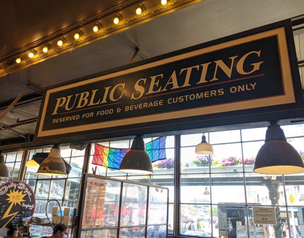 a sign for public seating at pike place market