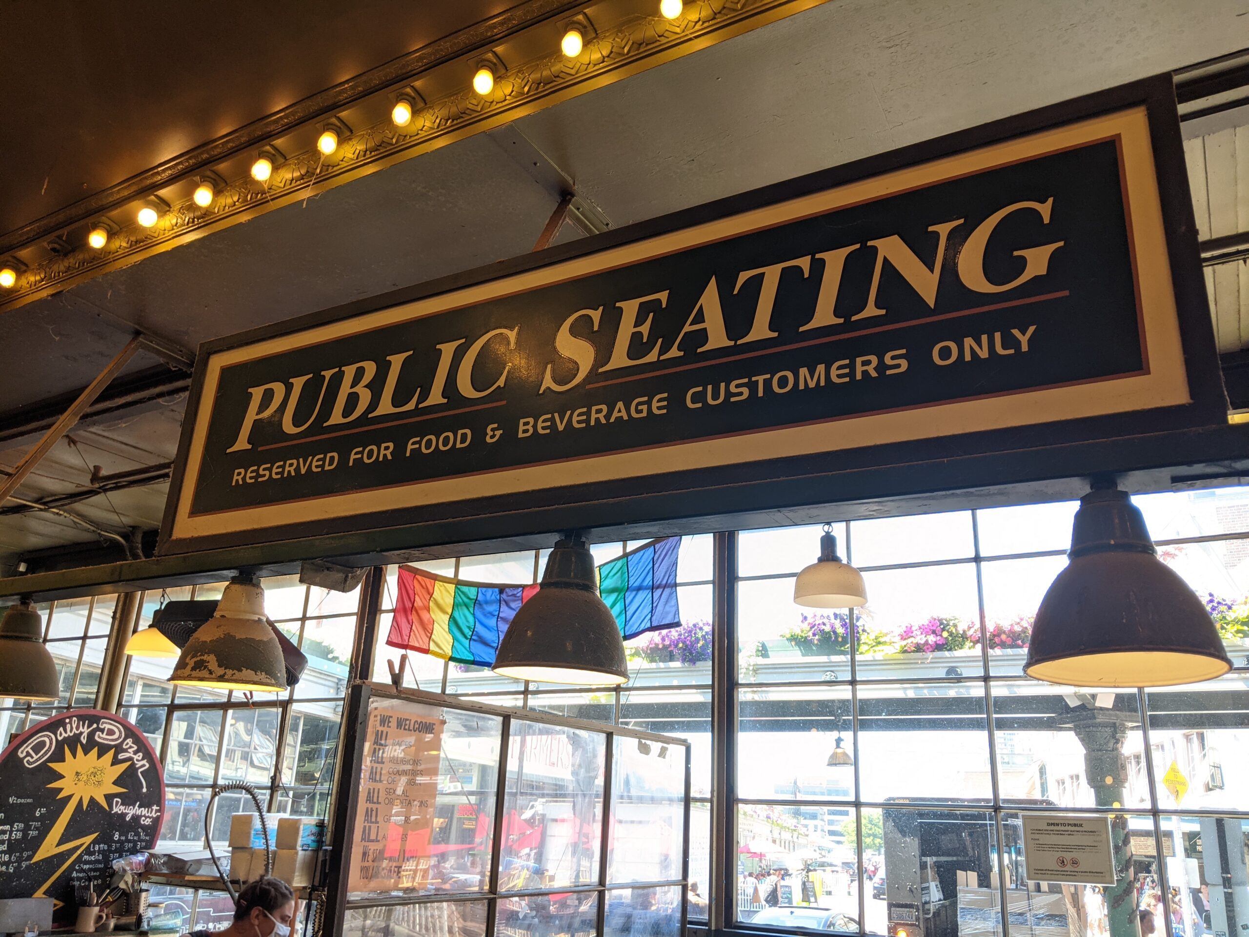 a sign for public seating at pike place market