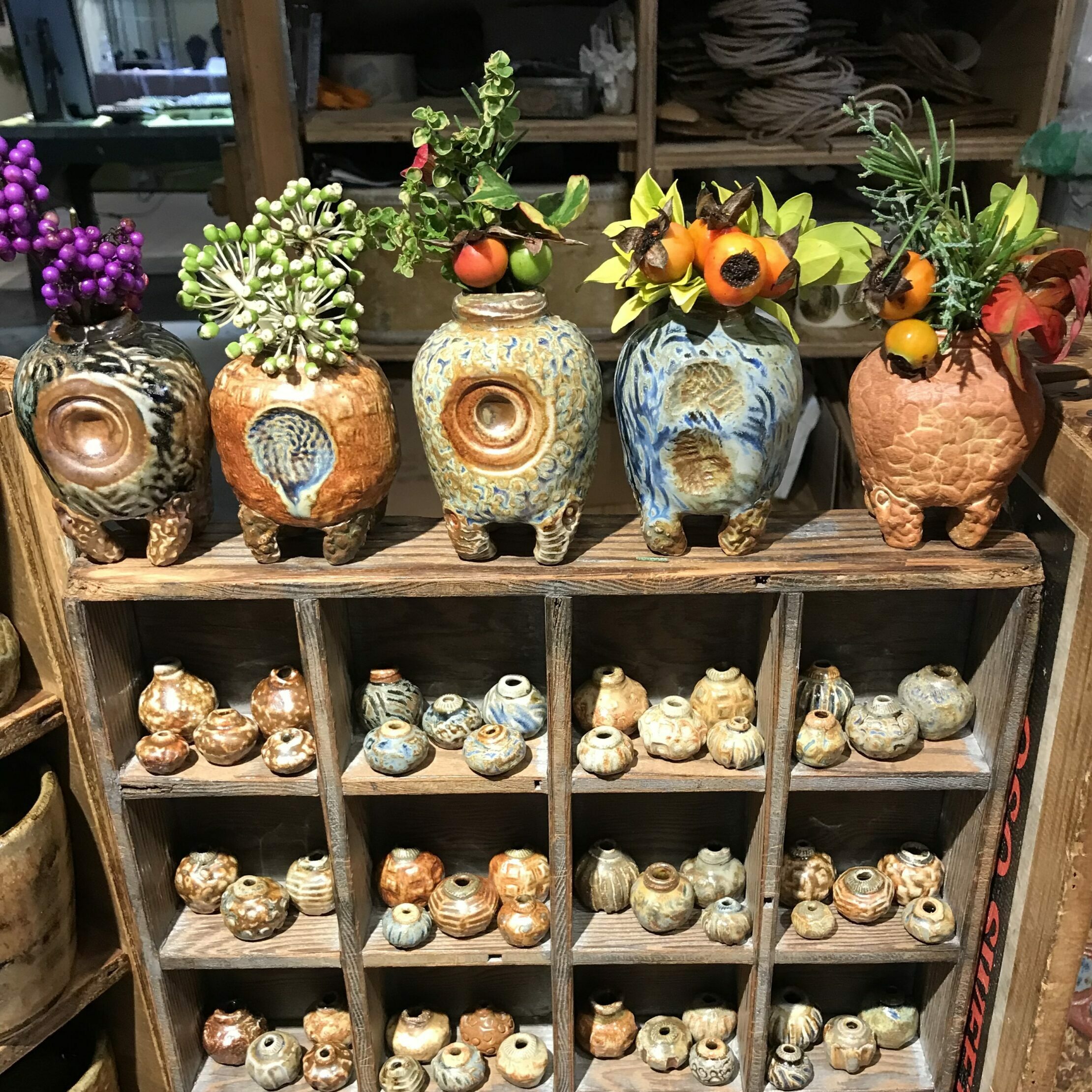 a display of clay vases from clay designs.benning a craftsperson in pike place market